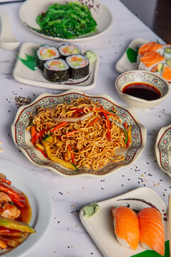 Variety of Asian food dishes served on the restaurant table.