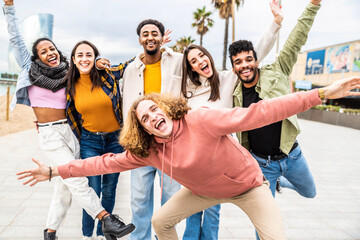 Multiracial group of people with hands up smiling at camera outside - Happy guys and girls having...