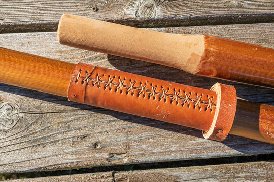 Pair of of wooden oars showing grip and leather collar