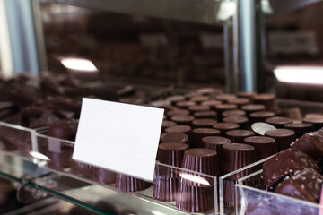  Closeup chocolate on display shelf on showcase in store with Mockup signboard 