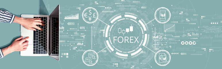 Fototapeta na wymiar Forex trading concept with person using a laptop computer