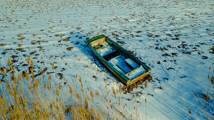Old abandoned boat sitting under a dusk sky