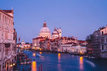 Fototapeta na wymiar Filtred scenery landscape with lights on water of Grand Canal during evening time for romantic sightseeing in Venezia, overview of ancient architecture buildings during international vacations