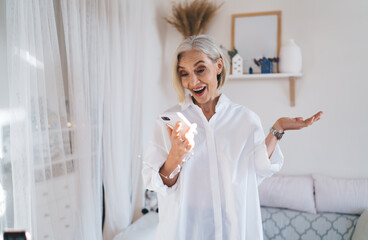 Senior caucasian woman using smartphone at home