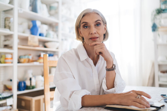 Businesswoman working at table at home art studio