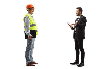 Businessman holding a document and talking to a mature male engineer