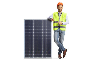 Full length portrait of a male engineer leaning on solar collector and pointing