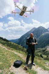 biker is recording images with a drone in the pyrenees