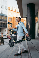 Fototapeta na wymiar Young modern man using and driving electric scooter on city street. Modern and ecological transportation concept.