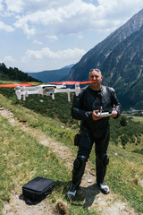 biker is recording images with a drone in the pyrenees