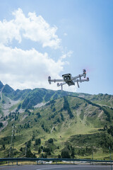 white drone flying in the pyrenees