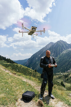 biker is recording images with a drone in the pyrenees