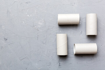 Flat lay composition with empty toilet paper rolls and space for text on color background. Recyclable paper tube with metal plug end made of kraft paper or cardboard