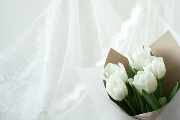 bouquet of white tulips on delicate silk background