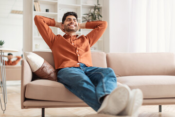 Arab man having rest at home on the couch