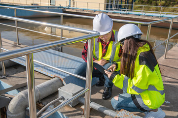 Environmental engineers work at wastewater treatment plants,Water supply engineering working at Water recycling plant for reuse,Technicians and engineers discuss work together.
