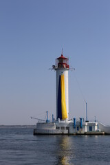 Fototapeta na wymiar Odessa vorontsov lighthouse with blue-yellow flag of Ukraine