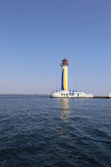 Fototapeta na wymiar Odessa vorontsov lighthouse with blue-yellow flag of Ukraine