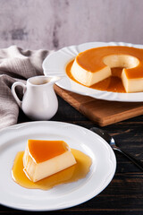 .Delicious condensed milk pudding on white plate. Featured piece.