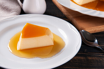 .Delicious condensed milk pudding on white plate. Featured piece.