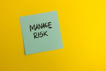 Text manage risk handwritten on sticky note