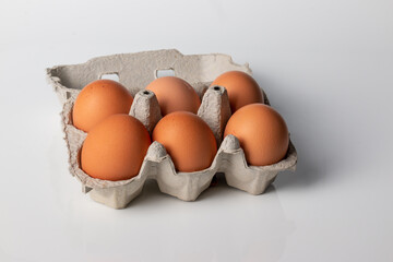 eggs in carton closeup on a white background