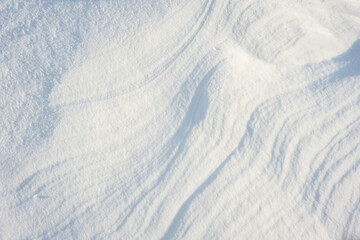 Coarse texture of the snow, accented by a sliding sun light