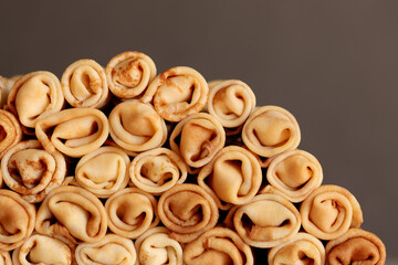 Stack of crepes rolls twisted with meat. Traditional Ukrainian russian thin pancakes as background....