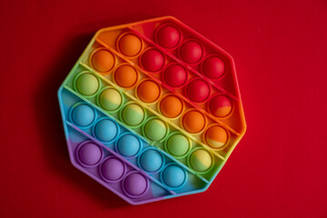 Pop it toy silicone on a red background.