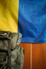 Military backpack. flag of ukraine on the background. close-up.