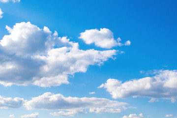 Bright scenic beautiful nature panoramic landscape of white puffy cumulus clouds floating in clear blue clear sky, skyline horizon backdrop background