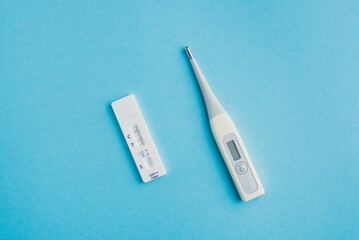 Covid-19 saliva self-test kit showing positive result. All employees are advised to have their temperature and coronavirus self-check before entering any office or facility.