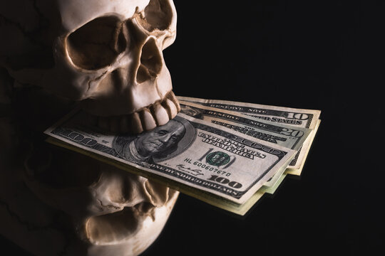 Skull and US dollars on a black background