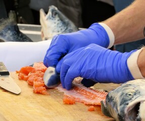 Selective focus of a Norwegian salmon being cleaned and filleted 