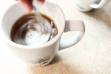 Cup of coffee being stirred