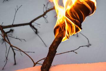 Fire in the woods. Torch in the winter forest