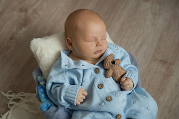 newborn baby boy in a suit sleeping on a  pillow props. Happy pregnancy and childbirth. Health concept. Happy pregnancy 