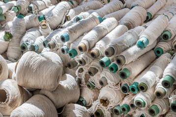 Old abandoned cotton spools of threads