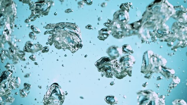 Super Slow Motion Shot of Oil Bubbles on Light Blue Background at 1000fps. Shoot on high speed cinema camera.