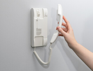 Hands opening door through intercom