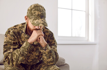 Stressed veteran soldier engrossed in depressive thoughts and memories. Sad depressed young...