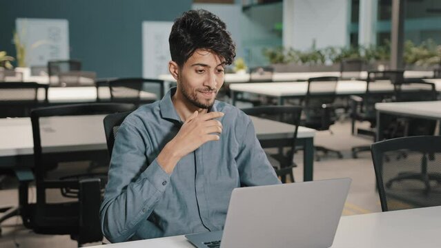 Millennial man Indian businessman using video conference app greeting employees waving hand hello gesture starting online briefing webchat conversation with colleagues concept self-isolation pandemic