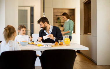 Young mother preparing breakfast for her family in the kitchen