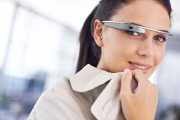 The future is now. Cropped portrait of an attractive young businesswoman using smartglasses in her office.