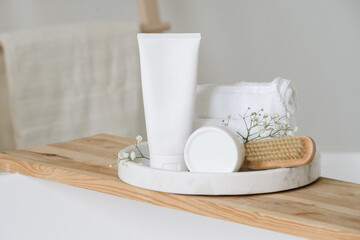 Blank cosmetic packaging mockup in bright bathroom
