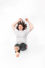 Plump woman does sports. Top view portrait of girl while playing sports on white background.