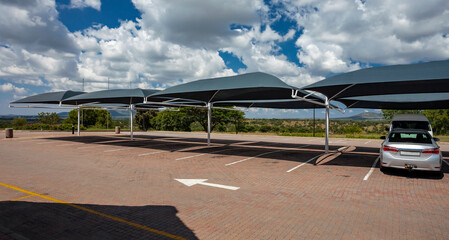 Car parking with awnings to create shade from the sun in Africa. - obrazy, fototapety, plakaty