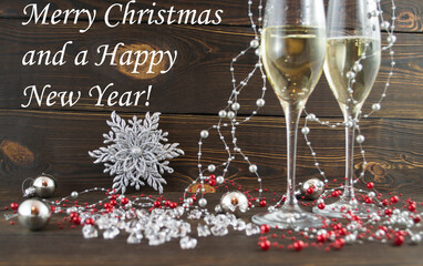 Cozy magical Christmas background for writing with Glasses of champagne and festive silver decoration deer fairy ornament on wooden vintage background