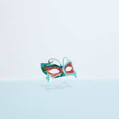 Venetian colorful carnival mask on pastel blue and white background. Theater or Carnival,...