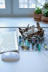 Gemstones crystals, Buddha, computer keyboard, mouse on table. Beautiful Sacred Work Space. Protect...